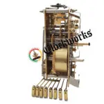 Side profile view of Hermle 1050-020 brass clock movement with visible gear trains and chime hammers