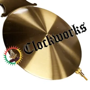 Bronze Kieninger lyre pendulum bob shown in a close-up front angle with brushed brass finish.